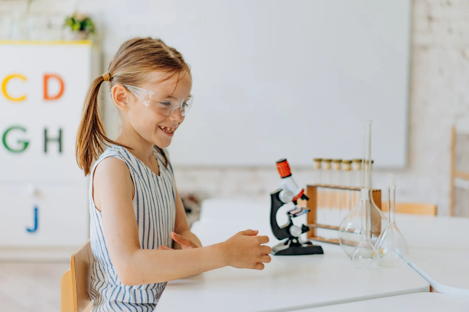 Student looking through a microscope in science class