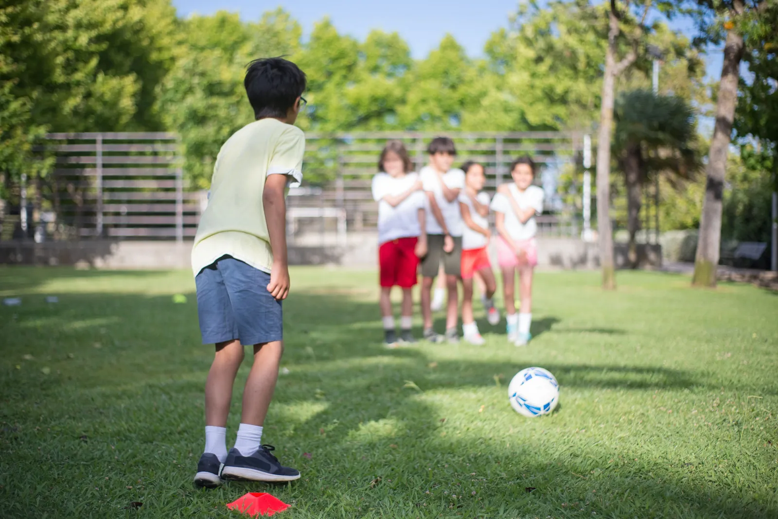 Students playing soccer on the school field