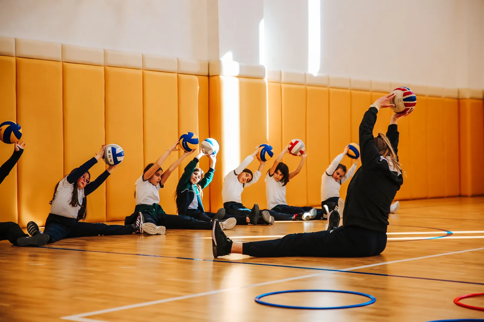 Students playing volleyball in the gym